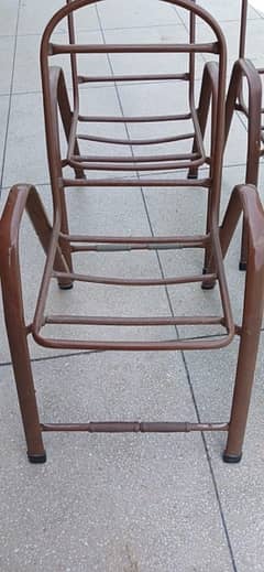 Four Citizen steel frame chairs without plastic seats and backs