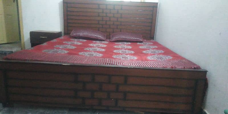 wooden bed with side tables and mattress 0