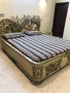 king sized bed with two side tables and a dressing