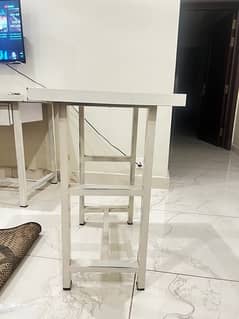 metal stand and wooden base table