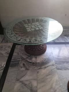 center table made of shisham wood  with a glass on it.