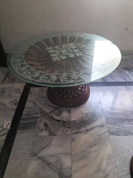 center table made of shisham wood  with a glass on it. 0