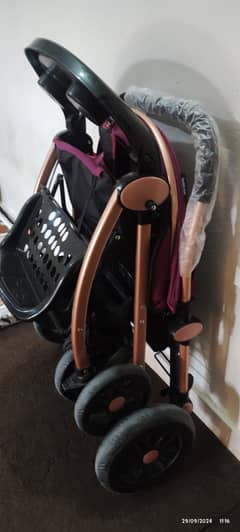 Two prams one in blue one in purple colour