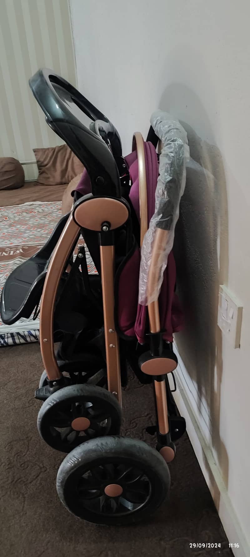 Two prams one in blue one in purple colour 2