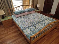 pine wood colour double bed with side tables.