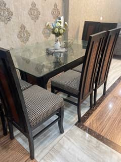 Glass top dining table set with 6 chairs.