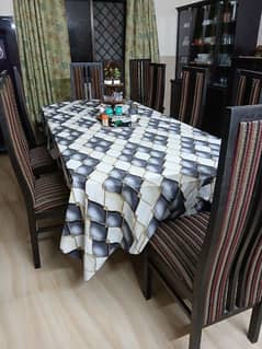 glass topped dining table with eight chair