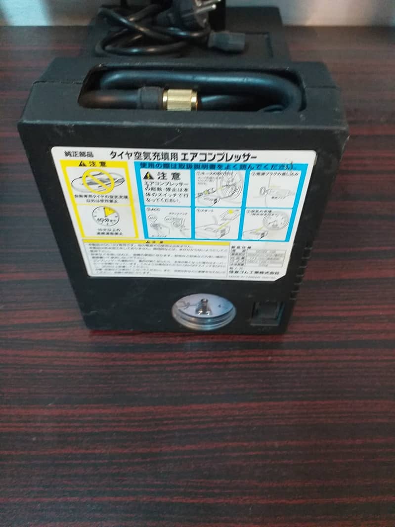 Japanese Portable Car Air Compressor Tire Inflator. 1