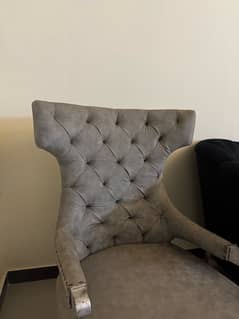 Black modern settee with two contrasting silver grey antique chairs