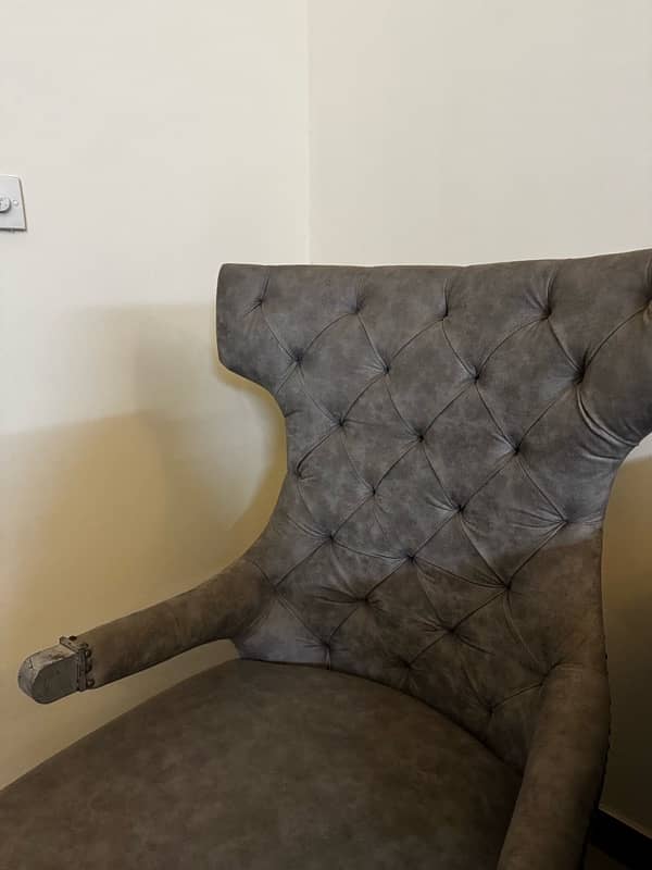 Black modern settee with two contrasting silver grey antique chairs 2