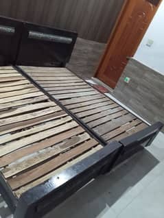 2 single wooden beds