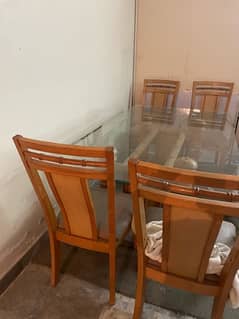 glasse dining table with four chairs