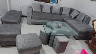 L shaped sofa with 2 stools and centre table