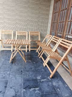 Six foldable wooden chairs with table