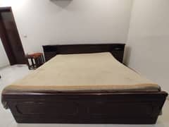 King size wooden bed with side tables and mattress