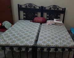 2 single iron rod bed