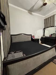 black king size bed with mattress and side table and dressing table