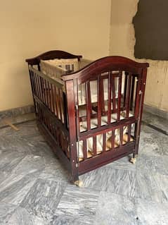 wooden baby cot with swing and a study table