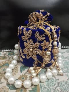 potli bag with pearl handle and tussel