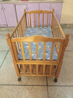 Baby Cot with 2 foldable doors and storage space.