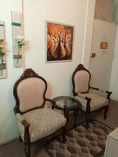 A beautiful pair of gulab chairs with coffee table.