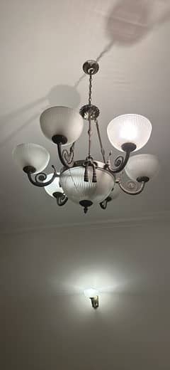 glass chandelier with three single wall light stands