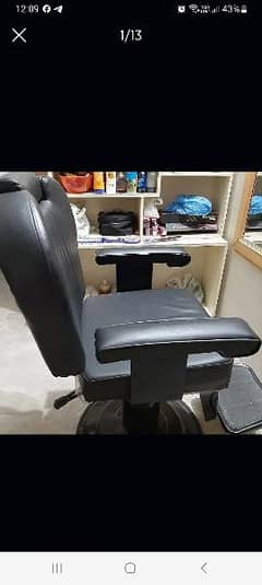 A beauty parlour chair and wooden rack