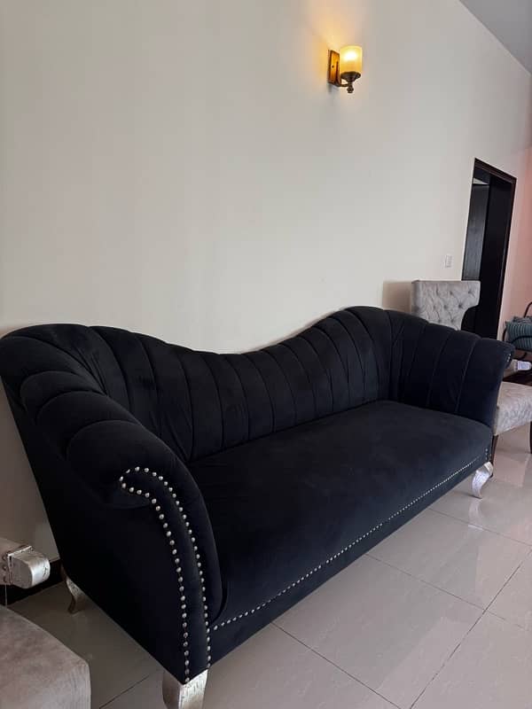 Black modern settee with two contrasting silver grey antique chairs 0