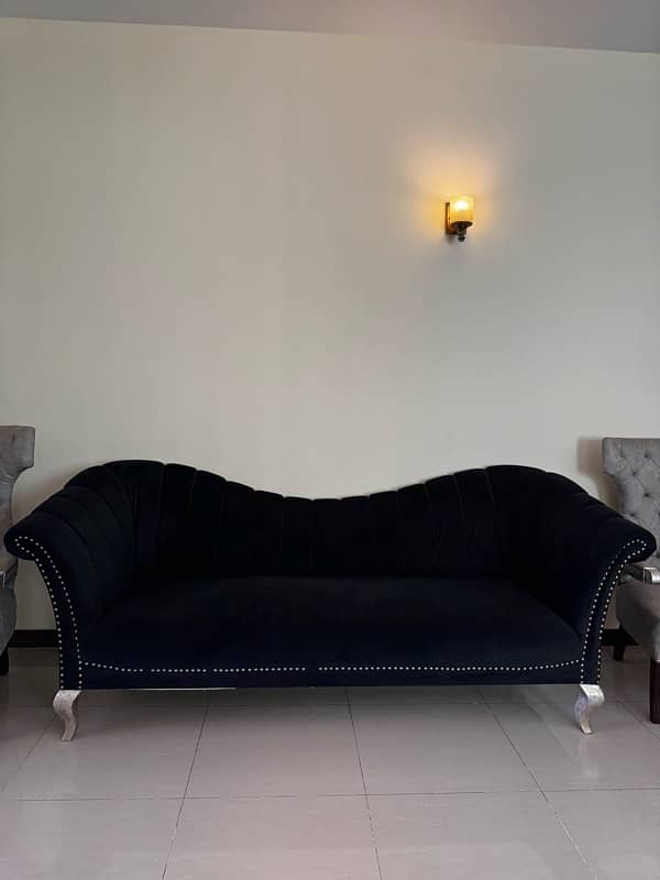 Black modern settee with two contrasting silver grey antique chairs 1