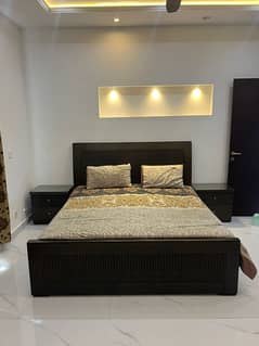 wooden bed with side table, dressing, mirror and mattress