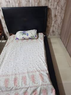 Single wooden bed low lying