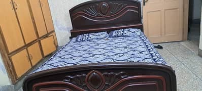 wooden bed with side tables and with medicated mattress.