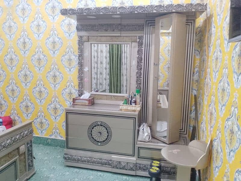 A bed with two sides tables and dressing table 4