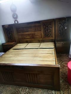 wooden bed with 2 side table