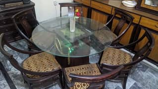 Glass round dining table with chairs touch wood