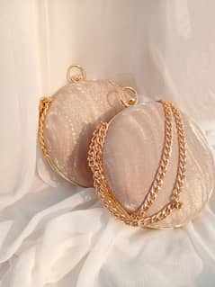 women's round shimmery clutch