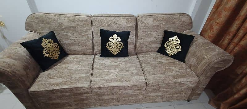 Urgent sell 7 seater sofa set with free wooden table and cushions 2