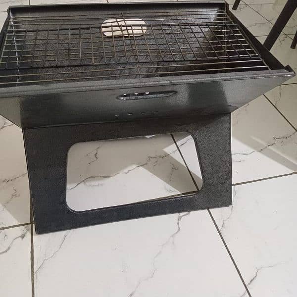 Portable and Foldable BBQ Stand with Grill in New Condition 1