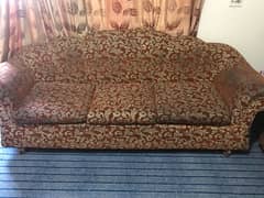 Sofa set of red color along with cream flower design