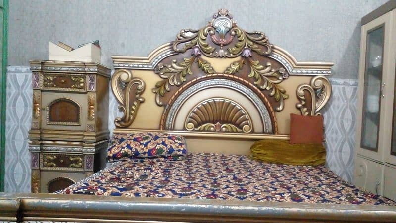 wood bed in good condition with mattreous and side tables. 1