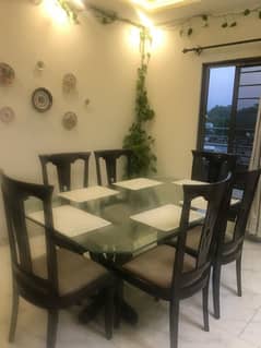 Glass top dining table with 6 chairs for 40k.