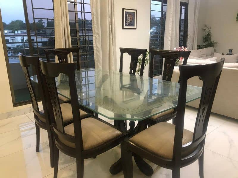 Glass top dining table with 6 chairs for 40k. 1