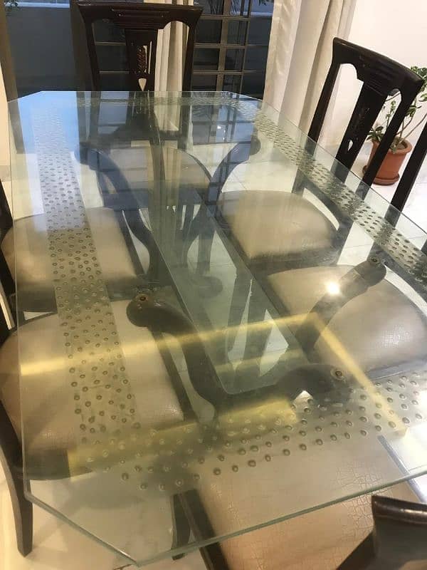 Glass top dining table with 6 chairs for 40k. 2