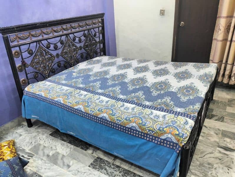 good condition rod iron bed with mattress 3