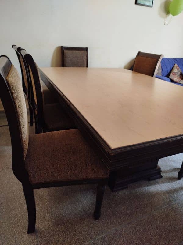 wooden compressed Formica table with eight cushioned chairs 2