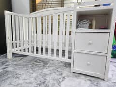 A WOODEN KIDS BED WITH DRAWERS