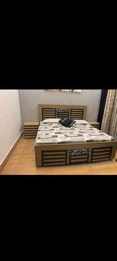 solid wood bed with two side tables. veey antic and elegant polish .