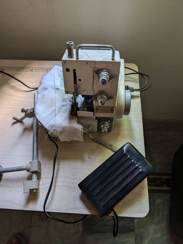 juki TL-82 Sewing machine with overlock machine on a wooden stand. 2