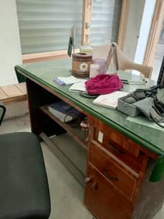 Office table neat and new condition with glass and green cloth cloth