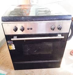 Cooking range with both gas and electric feature